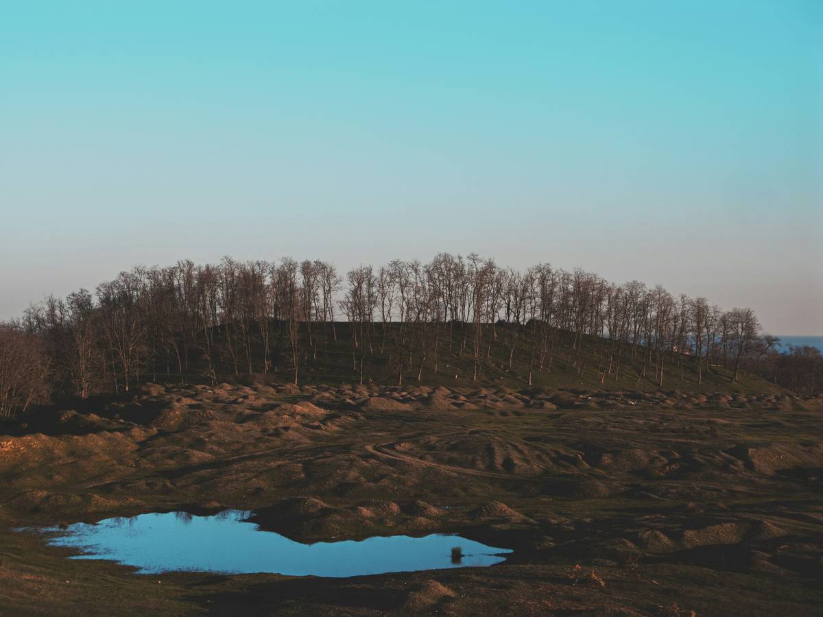 a hill with a lake in the middle of it