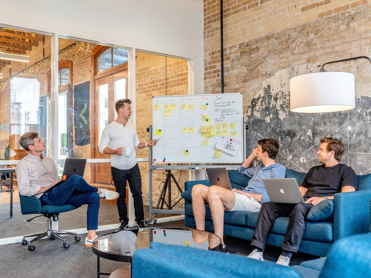 finance and procurement manager leading cross-functional team meeting